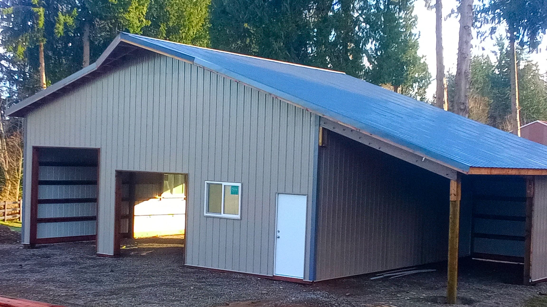 Another view of this 14' tall Probuilt metal building in Lake Tapps showing the practical layout with two 9'x8' and one 10'x10' overhead doors. The premium ash grey metal siding and charcoal roof provide long-lasting protection against Pacific Northwest weather conditions while offering ample space for vehicles, equipment, and storage.